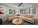 Inviting living room featuring a plush sectional sofa, ceiling fan, and large windows at 2324 Ithica Se Dr, Marietta, GA 30067