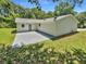 Rear exterior view of home with concrete patio and grassy lawn at 2492 Wild Rose Cir, Lawrenceville, GA 30044