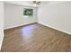 Bedroom featuring wood-look flooring, a ceiling fan and a window view at 2492 Wild Rose Cir, Lawrenceville, GA 30044