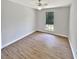 Bedroom featuring wood-look flooring, a ceiling fan and window at 2492 Wild Rose Cir, Lawrenceville, GA 30044