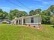 Exterior view of house with large lawn and mature trees at 2492 Wild Rose Cir, Lawrenceville, GA 30044