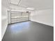 Spacious garage featuring a new gray floor and white walls at 2492 Wild Rose Cir, Lawrenceville, GA 30044