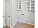 Bright laundry room with tile floors and white cabinets at 2492 Wild Rose Cir, Lawrenceville, GA 30044