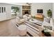 Bright living room boasts a stone fireplace, neutral paint, and modern furniture for a cozy, stylish space at 2492 Wild Rose Cir, Lawrenceville, GA 30044