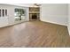Spacious living room features wood-look floors, stone fireplace, neutral paint, and a large window at 2492 Wild Rose Cir, Lawrenceville, GA 30044