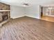 Bright living room features a stone fireplace, ceiling fan and wood-look flooring at 2492 Wild Rose Cir, Lawrenceville, GA 30044