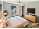 Inviting bedroom with a light wood bed frame, dresser, large window, and closet for ample storage at 2492 Wild Rose Cir, Lawrenceville, GA 30044