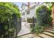 A gated pathway leads to an outdoor patio surrounded by mature trees and meticulous landscaping at 4356 N Buckhead Ne Dr, Atlanta, GA 30342