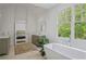 Bright bathroom featuring a soaking tub and an ensuite view of the bedroom at 4356 N Buckhead Ne Dr, Atlanta, GA 30342