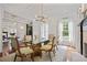 Elegant dining room featuring hardwood floors, modern lighting, and large windows at 4356 N Buckhead Ne Dr, Atlanta, GA 30342