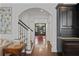 Bright foyer features a dark entry door, hardwood floors, and stairs to the upper level at 4356 N Buckhead Ne Dr, Atlanta, GA 30342