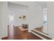 Hallway with hardwood floors leads to several rooms and a raised step into another area at 4356 N Buckhead Ne Dr, Atlanta, GA 30342
