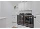 Laundry room equipped with washer and dryer, white cabinets, and tile floors at 4356 N Buckhead Ne Dr, Atlanta, GA 30342