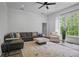 Spacious living room features a large window, a ceiling fan, and a plush couch at 4356 N Buckhead Ne Dr, Atlanta, GA 30342