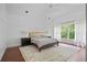 Spacious main bedroom featuring a tray ceiling, a large window, and a decorative rug at 4356 N Buckhead Ne Dr, Atlanta, GA 30342