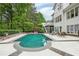 The stunning in-ground pool is surrounded by lush landscaping and a stone patio at 4356 N Buckhead Ne Dr, Atlanta, GA 30342