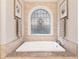 Relaxing soaking tub with a decorative window, providing a tranquil retreat for rejuvenation at 10635 N Edgewater, Johns Creek, GA 30097