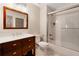 Bathroom with a stylish vanity, mirror, and shower-tub combination with a glass door at 10635 N Edgewater, Johns Creek, GA 30097