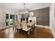 Bright dining room with fireplace, modern chandelier, and ample seating at 10635 N Edgewater, Johns Creek, GA 30097