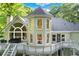 Exterior view showcasing a large deck, stone accents and unique architecture at 10635 N Edgewater, Johns Creek, GA 30097