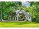 Charming traditional home with lush landscaping and a well-manicured lawn at 10635 N Edgewater, Johns Creek, GA 30097