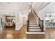 Grand foyer features hardwood floors, staircase, and views of the dining room and kitchen at 10635 N Edgewater, Johns Creek, GA 30097