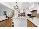 Open kitchen featuring a large island with bar seating and stainless steel appliances at 10635 N Edgewater, Johns Creek, GA 30097