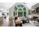 Bright living room featuring an expansive window, fireplace, and hardwood floors at 10635 N Edgewater, Johns Creek, GA 30097