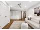 Spacious living room featuring a white sofa, built-in shelving, and a decorative rug at 10635 N Edgewater, Johns Creek, GA 30097