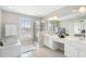 Bathroom with double vanity, large mirror, glass-enclosed shower, and bathtub at 4855 Payson Se Ter # 3, Atlanta, GA 30339