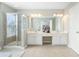 Bright bathroom featuring a glass-enclosed shower and double vanity with white cabinets and ample countertop space at 4855 Payson Se Ter # 3, Atlanta, GA 30339