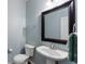 Powder room features a pedestal sink, framed mirror, and updated fixtures at 4855 Payson Se Ter # 3, Atlanta, GA 30339