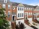 Brick townhomes with attached garages, well-maintained landscaping, and inviting entrances at 4855 Payson Se Ter # 3, Atlanta, GA 30339