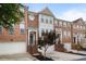 Attractive brick townhouse with a two-car garage and landscaped front with mature tree at 4855 Payson Se Ter # 3, Atlanta, GA 30339