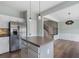 Modern kitchen with stainless steel appliances, an island, and hardwood floors that leads to a dining area with lots of natural light at 4855 Payson Se Ter # 3, Atlanta, GA 30339