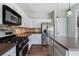 Open kitchen with stainless steel appliances, an island, and attractive backsplash at 4855 Payson Se Ter # 3, Atlanta, GA 30339