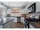 Updated kitchen featuring a center island, stainless appliances, and wood floors at 4855 Payson Se Ter # 3, Atlanta, GA 30339