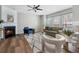 Cozy living room with a fireplace, ceiling fan, and large windows for natural light at 4855 Payson Se Ter # 3, Atlanta, GA 30339