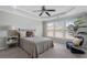 Bedroom with carpeted floor, tray ceiling, fan, and large windows at 4855 Payson Se Ter # 3, Atlanta, GA 30339
