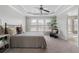 Bedroom with carpeted floor, tray ceiling, fan, large windows, and ensuite bathroom at 4855 Payson Se Ter # 3, Atlanta, GA 30339