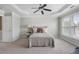 Bedroom with carpeted floor, tray ceiling, fan, and large windows at 4855 Payson Se Ter # 3, Atlanta, GA 30339