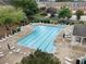 Community pool area with lounge chairs, umbrellas, and lush green landscaping at 4855 Payson Se Ter # 3, Atlanta, GA 30339