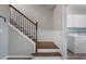 Staircase with wood treads, black iron spindles, and white paneled wainscoting at 4855 Payson Se Ter # 3, Atlanta, GA 30339