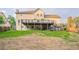 Home's backyard features a wooden deck with stairs, set in a spacious, green landscape at 5696 Glandor Dr, Mableton, GA 30126
