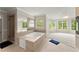 Bright bathroom with a large soaking tub, walk-in shower, large windows, and lots of natural light at 789 Rutland Ct, Lithonia, GA 30058