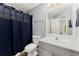 Bathroom features a single sink with a white countertop, gray cabinets, and a blue patterned shower curtain at 789 Rutland Ct, Lithonia, GA 30058