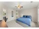 Bright bedroom featuring a ceiling fan and a door with mirrored glass that opens into the bathroom at 789 Rutland Ct, Lithonia, GA 30058