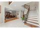 Spacious foyer with a staircase and iron spindles, adjacent to the dining room, offering an open layout at 789 Rutland Ct, Lithonia, GA 30058