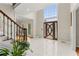 Grand two-story foyer with tile floors, a decorative front door, and a large window allowing natural light at 789 Rutland Ct, Lithonia, GA 30058