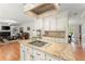 Open concept kitchen island with granite countertops offering seamless flow into the living room at 789 Rutland Ct, Lithonia, GA 30058